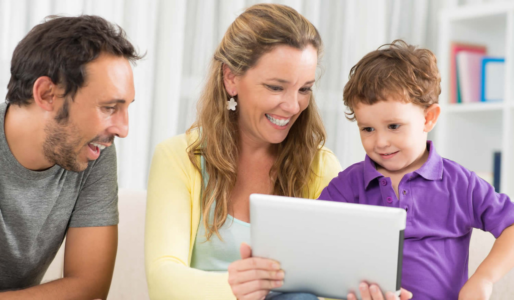 Cheerful mother showing the latest tablet results London City Mortgages