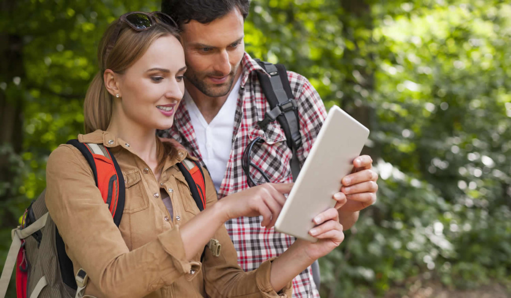 Couple accessing their tablet updates outdoors, London City Mortgages