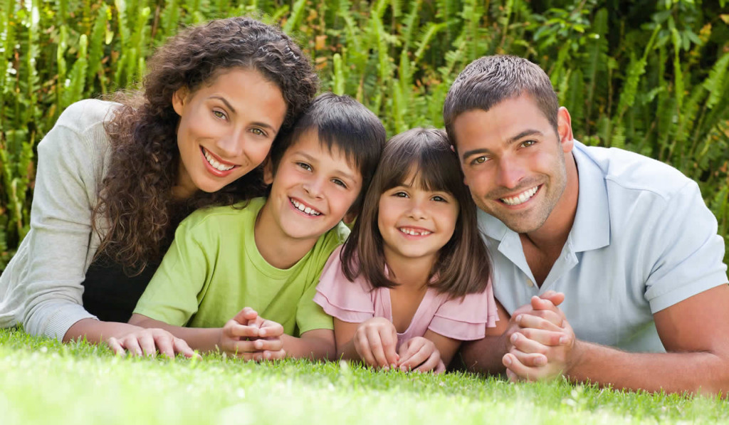 Happy family enjoying their garden at home, London City Mortgages