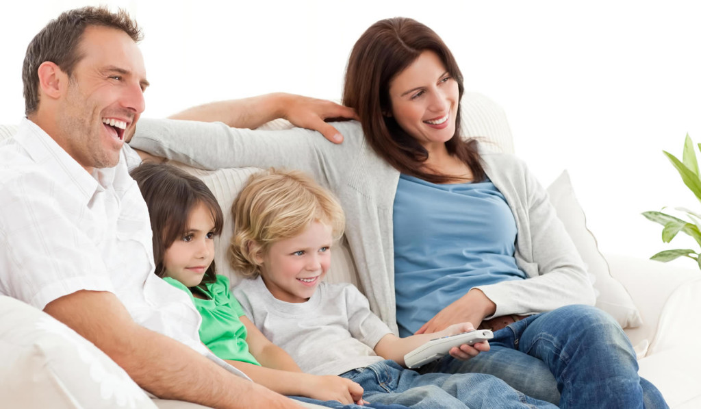 Happy family watching television at home, London City Mortgages