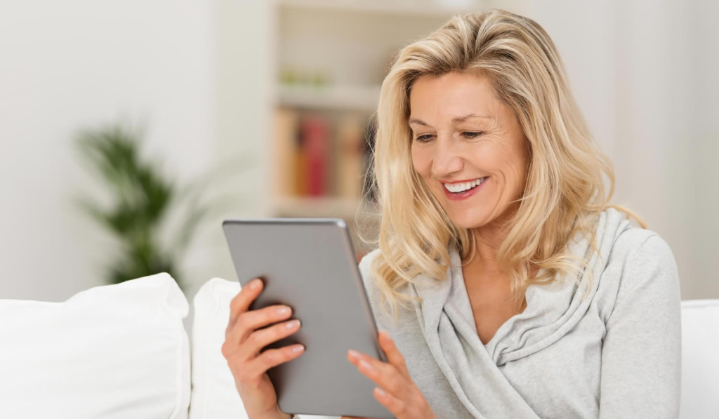 Middle aged women pleased with her tablet results, London City Mortgages