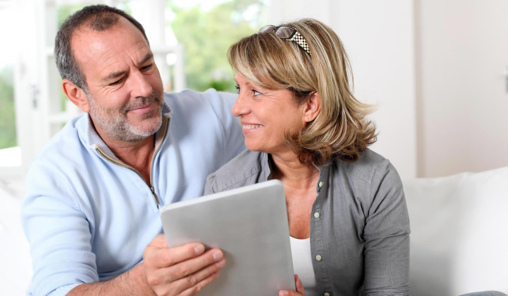 Older couple viewing pages on their laptop, London City Mortgages