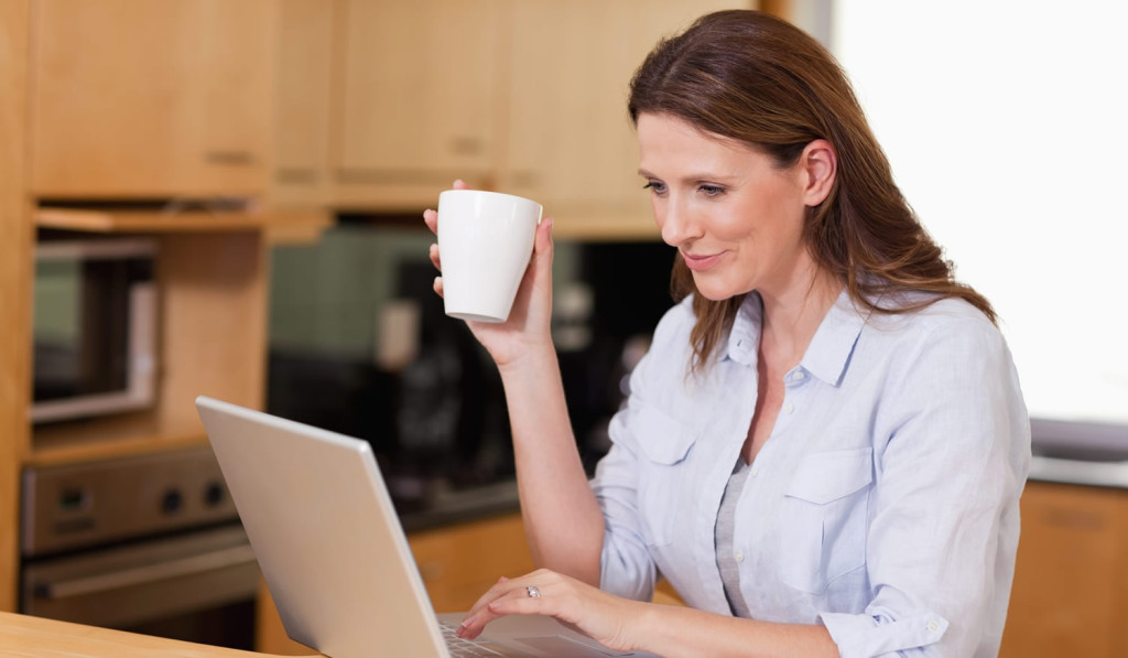 Women drinking coffee while receiving her laptop-notices, London City Mortgages