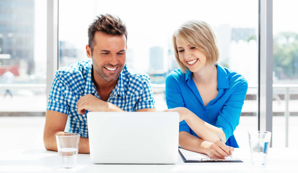 Young couple pleased with their tablet results, London City Mortgages