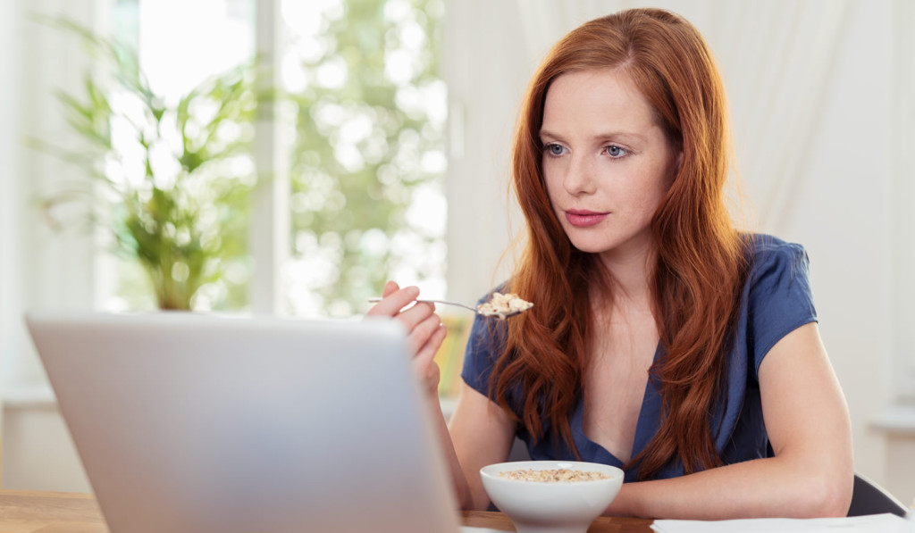 Breakfast with woman looking at laptop news London City Mortgages