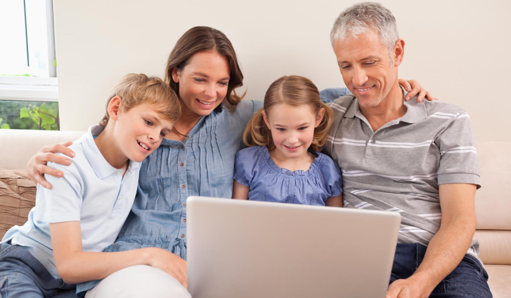 Indoors family reviewing their tablet London City Mortgages