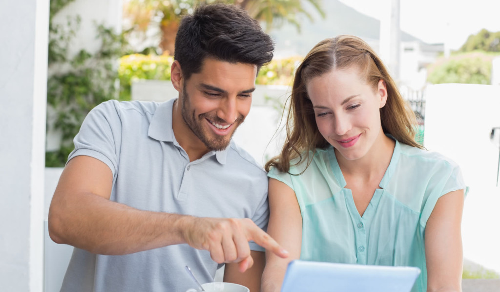 Terrace with smiling couple on laptop London City Mortgages